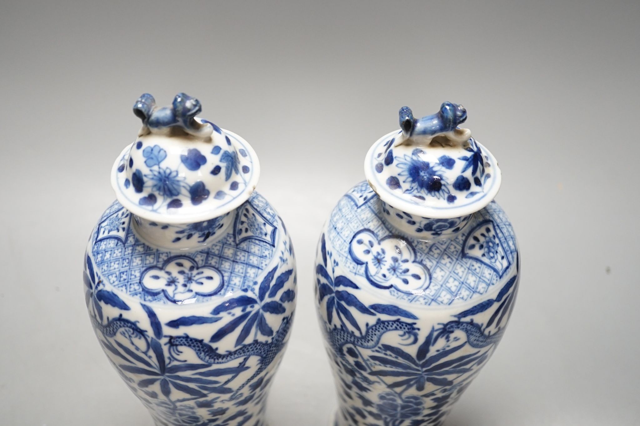 A pair of Chinese blue and white dragon vases and covers, circa 1900. 28cm